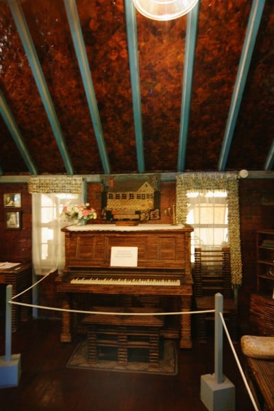 piano covered in newspaper in Paper House